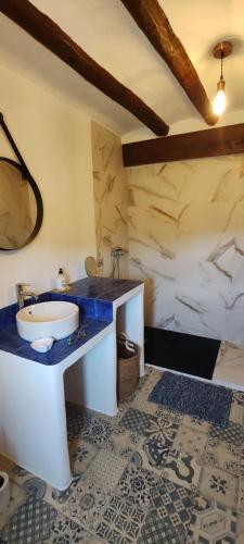 a bathroom with a sink and a mirror at Casa la Solana 1915 in Lucena del Cid