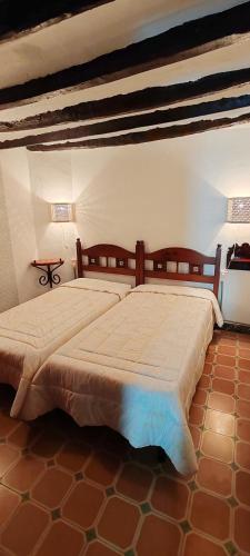 a bedroom with a large bed and a table at Casa la Solana 1915 in Lucena del Cid