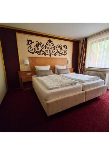 a bedroom with two large beds in a room at Parkhotel Waldbreitbach in Waldbreitbach