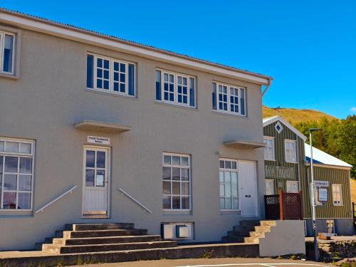 an apartment building with blue windows and stairs at Hótel Tindastóll in Sauðárkrókur