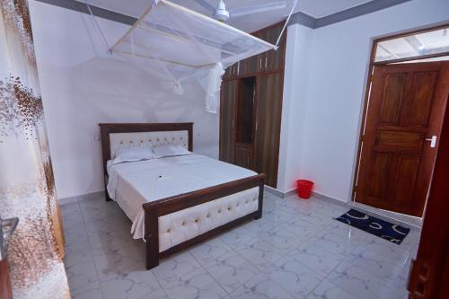 a bedroom with a bed with a canopy in it at Talia holiday home ,Malindi kenya -1 in Malindi