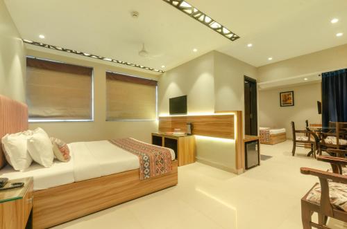 a bedroom with a bed and a living room at Hotel Jullundur 18 in Chandīgarh