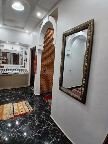 a mirror hanging on a wall in a room at فيلا رياض عمران in Douar Blidene