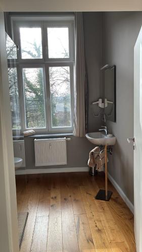 a bathroom with a sink and a window at Gästehaus LeLo 6 in Solingen