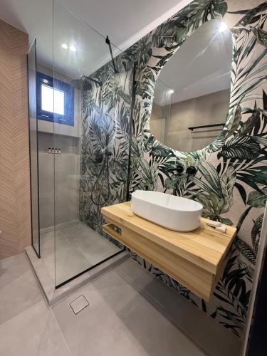 a bathroom with a sink and a shower at Akroyiali Resort in Vasiliki