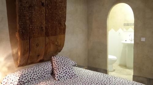 a bedroom with a bed with two pillows on it at Casa Rural Alamar II in Tiedra