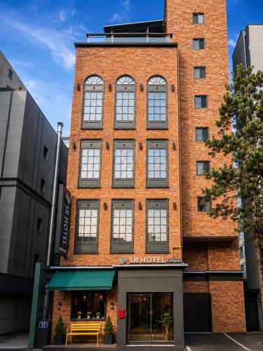 a brick building with a store in front of it at SR Compact Hotel Sinchon in Seoul