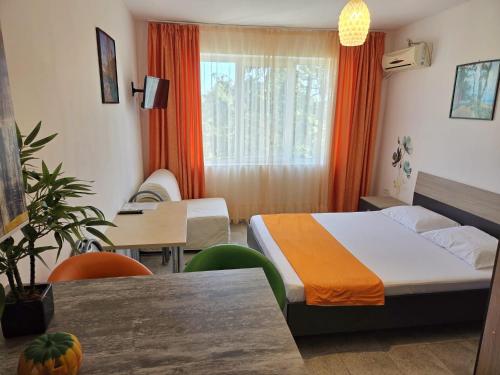 a hotel room with a bed and a table at Geo Studios in Saturn