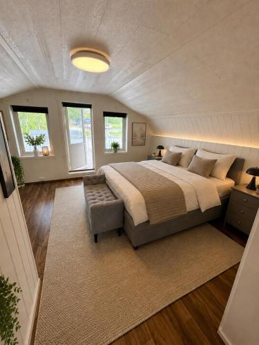 a bedroom with a large bed and a couch at Willes Wellness Paradise in Herjenes