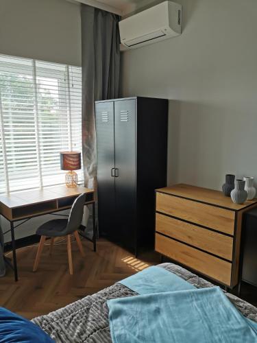 a bedroom with a desk and a table and a bed at Apartament Kamil Kalisz in Kalisz