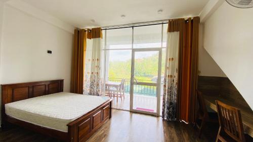 a bedroom with a bed and a sliding glass door at 97 Ella in Ella