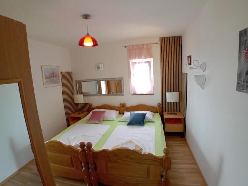 a bedroom with a large bed in a room at D,apartman' ulica pušća 51, 51513 Omišalj in Omišalj
