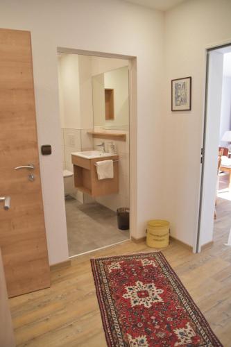 a bathroom with a sink and a mirror at Landhaus Lena in Schönwald