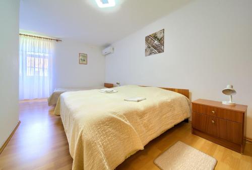 a bedroom with a bed and a dresser and a window at Kuca za odmor Kornic in Kornić