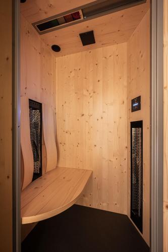 a room with a wooden wall with a wooden shelf at Alpenrose in Obermaiselstein