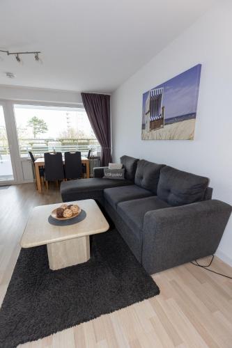 a living room with a couch and a table at Hanseatic 110 in Duhnen