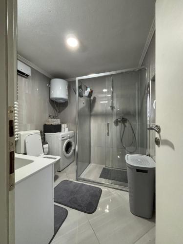 a bathroom with a shower and a toilet and a sink at Apartman DIN in Travnik