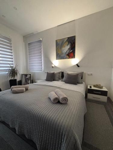 a bedroom with a large bed with towels on it at Apartman DIN in Travnik