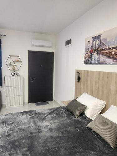 a bedroom with a bed and a black door at DD Apartmani in Sutorina