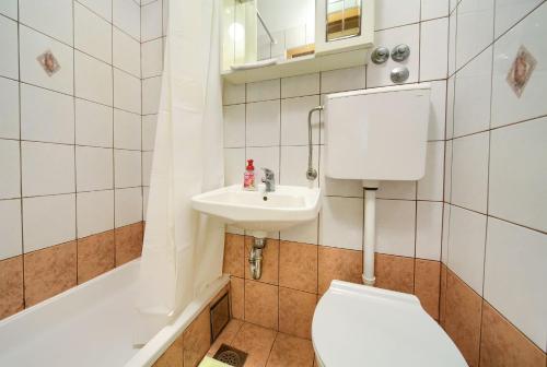 a bathroom with a toilet and a sink and a tub at Apartments Jurina 2 in Krk