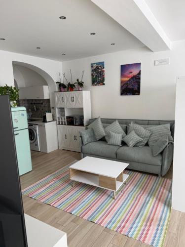 a living room with a couch and a coffee table at Hostel Brikette in Positano