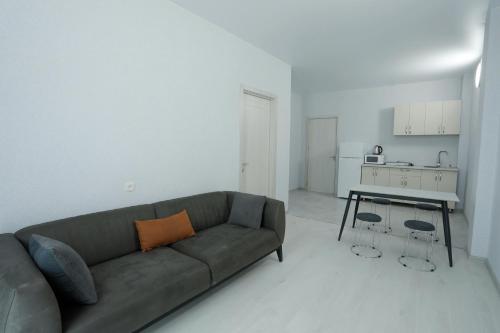 a living room with a couch and a table at Shekvetili Sunset Apartments in Shekhvetili