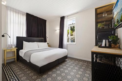 a hotel room with a bed and a window at City Port Hotel by Sea N Rent in Haifa