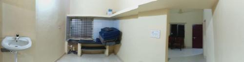 a bathroom with a sink and a toilet in a room at Eden Homes in Honāvar