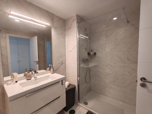 a bathroom with a sink and a shower and a tub at Vitta Nature Spa - 3 bedrooms in Mijas Costa