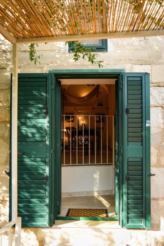 an open door to a house with green shutters at Lues Incanto in Ragusa