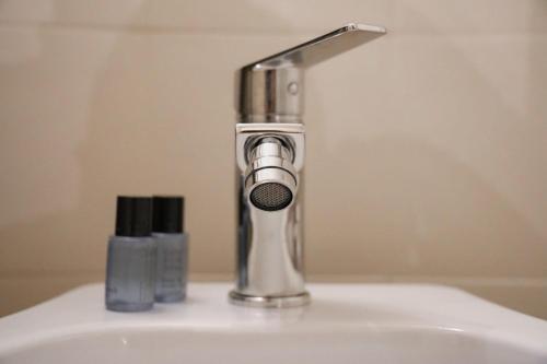 a bathroom sink with a faucet on top of it at Lues Incanto in Ragusa