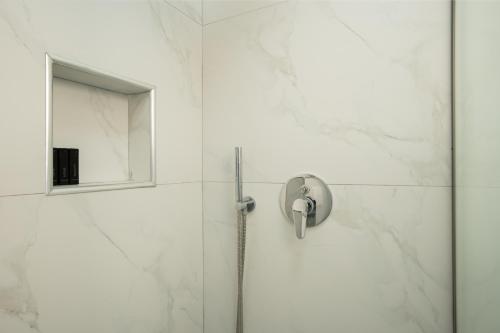 a bathroom with a shower with a mirror at Joni's Condo 10 in Golem