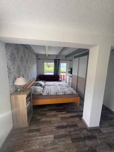 a bedroom with a bed and a window at Berghaus Gesäuse Pension in Weng im Gesäuse