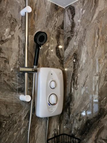 a hair dryer is attached to a stone wall at The Florence Guest House in Whitby