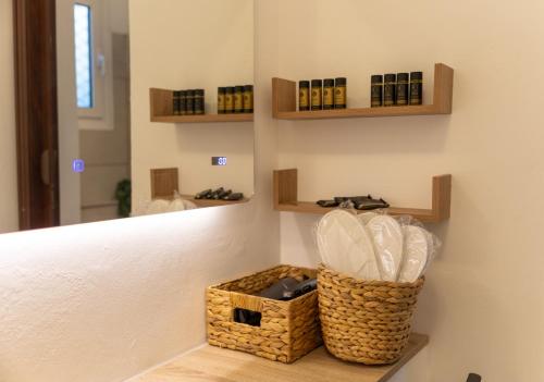 a room with a mirror and a basket on the wall at San House 1 in Archangelos