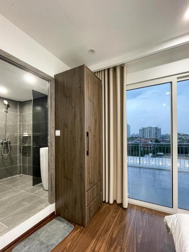 a bathroom with a shower and a large window at Sky villas with large balcony in Hanoi