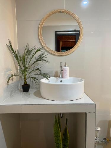 a bathroom with a white sink and a mirror at Bunga Lodge Tetebatu in Tetebatu