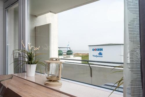 a glass table with a vase on top of a window at Hanseatic 208 in Duhnen