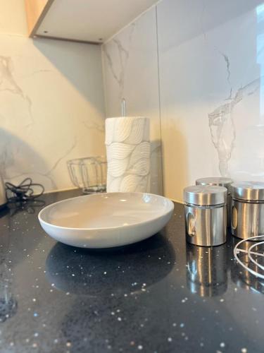 a white bowl sitting on top of a counter at Luxury Apartment - Breathtaking River Views in Kyalami