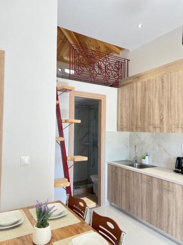 a kitchen with a table with chairs and a ladder at evelinas view 3 in Mytilene