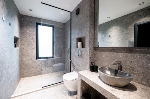 a bathroom with a sink and a shower and a toilet at Chalet Rila in Govedartsi