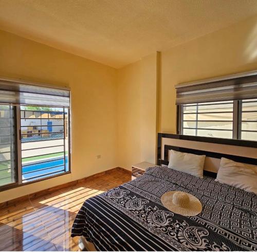 a bedroom with a large bed and two windows at Shamsa Chalet in Al Mazār