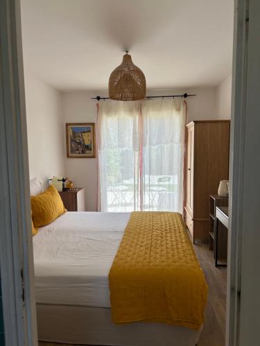 a bedroom with a large bed and a window at Chambre Villa piscine in Saint-Tropez