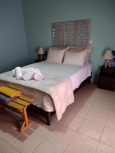 a bedroom with a large bed with towels on it at IthakiHouse II in Vathi