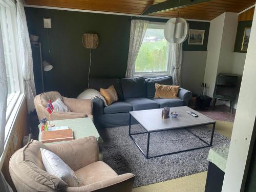 a living room with couches and a coffee table at Tiritoppen Cabin in Loen