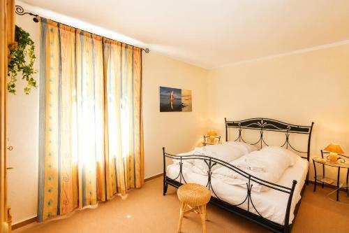 a bedroom with a black bed and a window at Apartmenthaus Ostseewelle Ferienwohnung 13 in Kühlungsborn