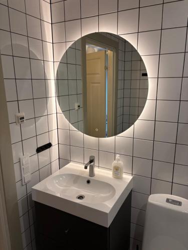 a bathroom with a sink and a mirror at Lomma Station Inn in Lomma