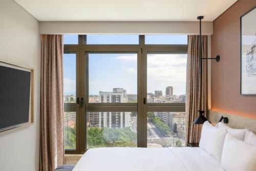 a hotel room with a bed and a large window at Residence Inn Lisbon by Marriott Hotel in Lisbon