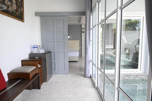 a room with a door and a room with a bedroom at Sichon Goodwill in Sichon