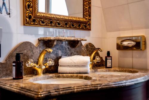 a bathroom with two sinks and a mirror at La Villa Royale in Paris
